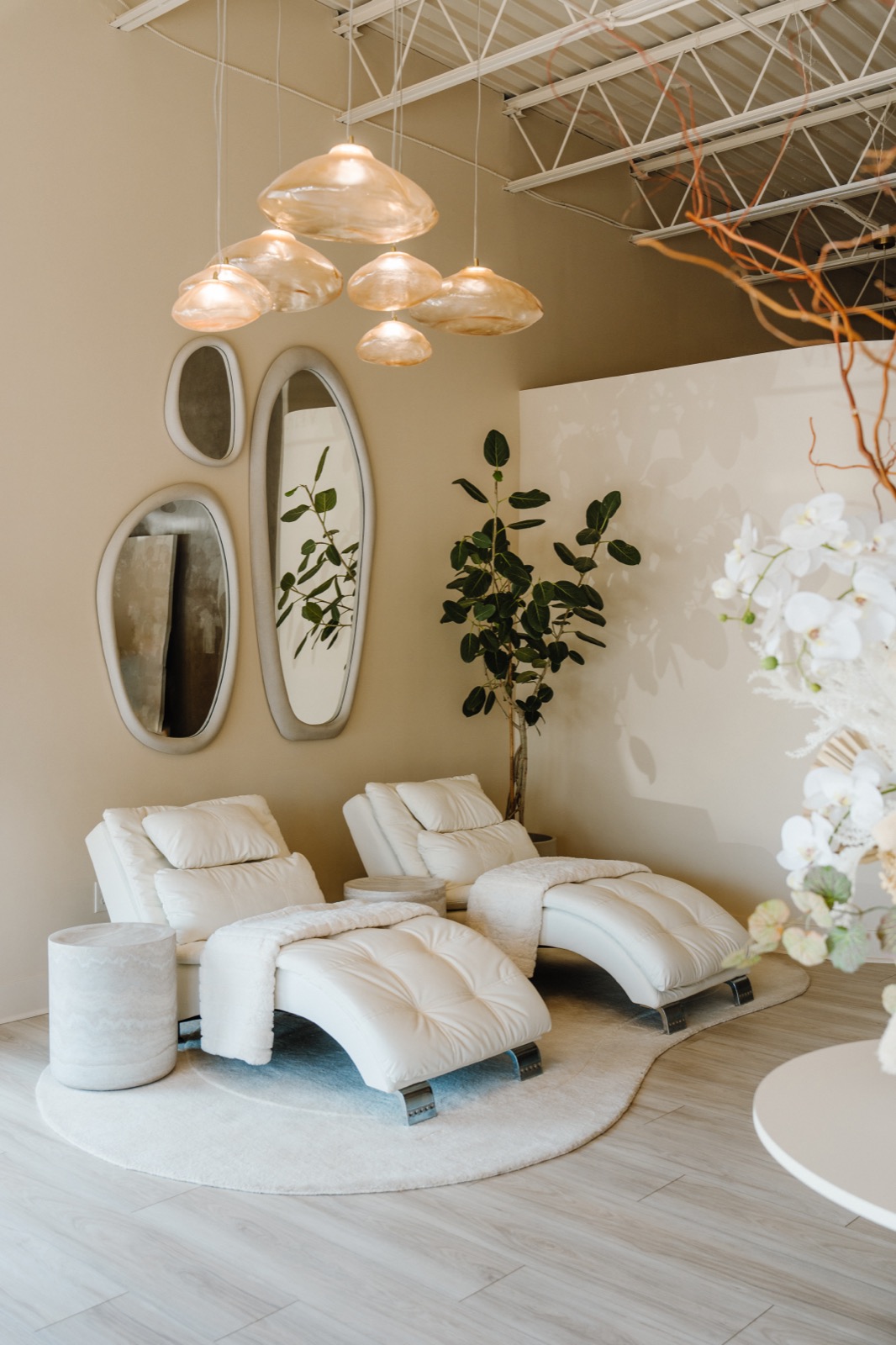 White chaise loungers under glass pendant lights in the Rêve Wellness relaxation area
